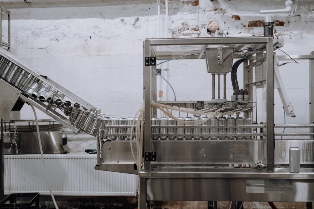 Automated beverage can packaging in a modern factory setting.